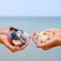 One Guest holding handfuls of litter and another holding handfuls of seashells